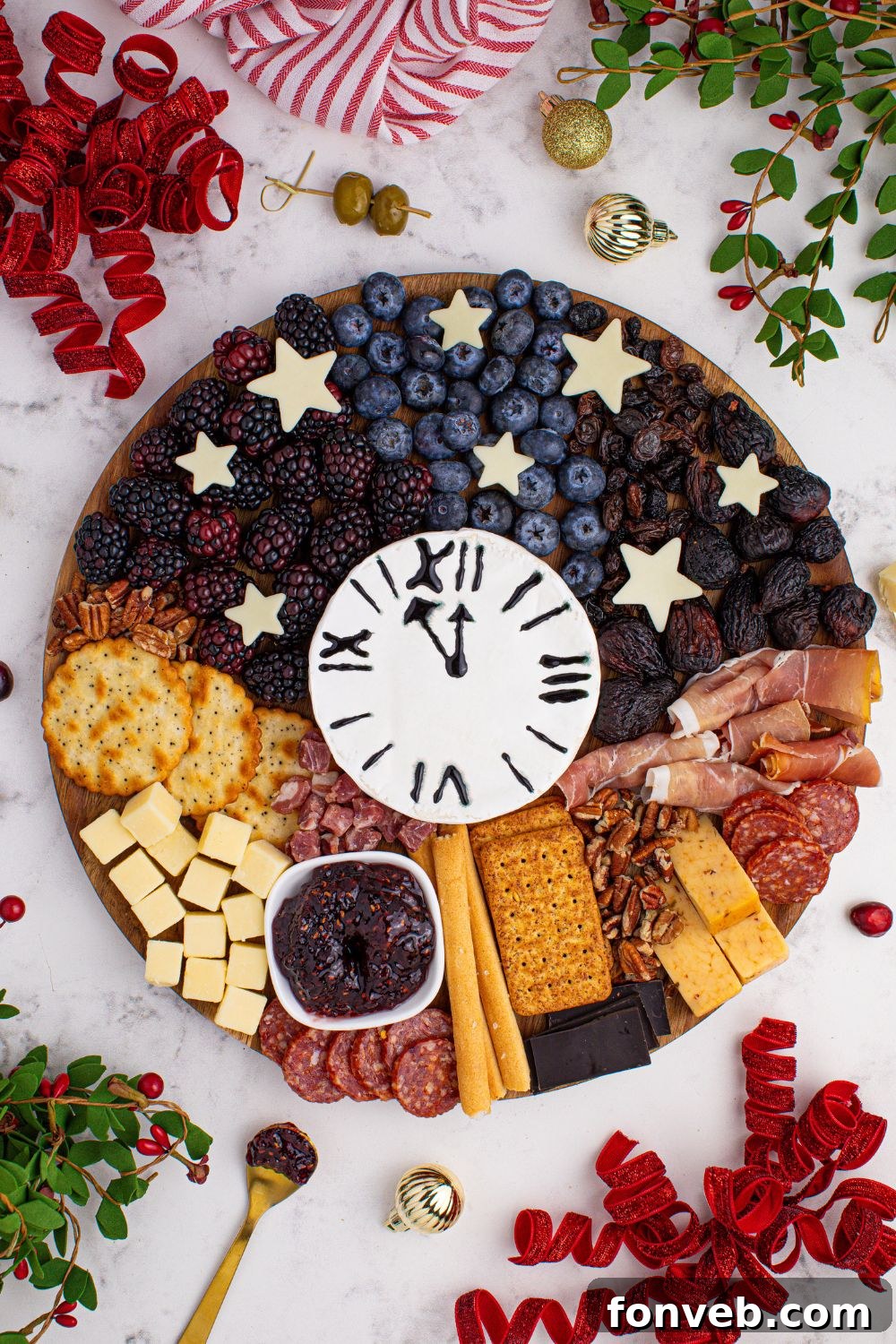 An inviting overhead shot of the New Year's Eve Charcuterie Board on a table, showcasing a rich variety of nuts, cheeses, berries, and other delicious items spread across the serving tray.