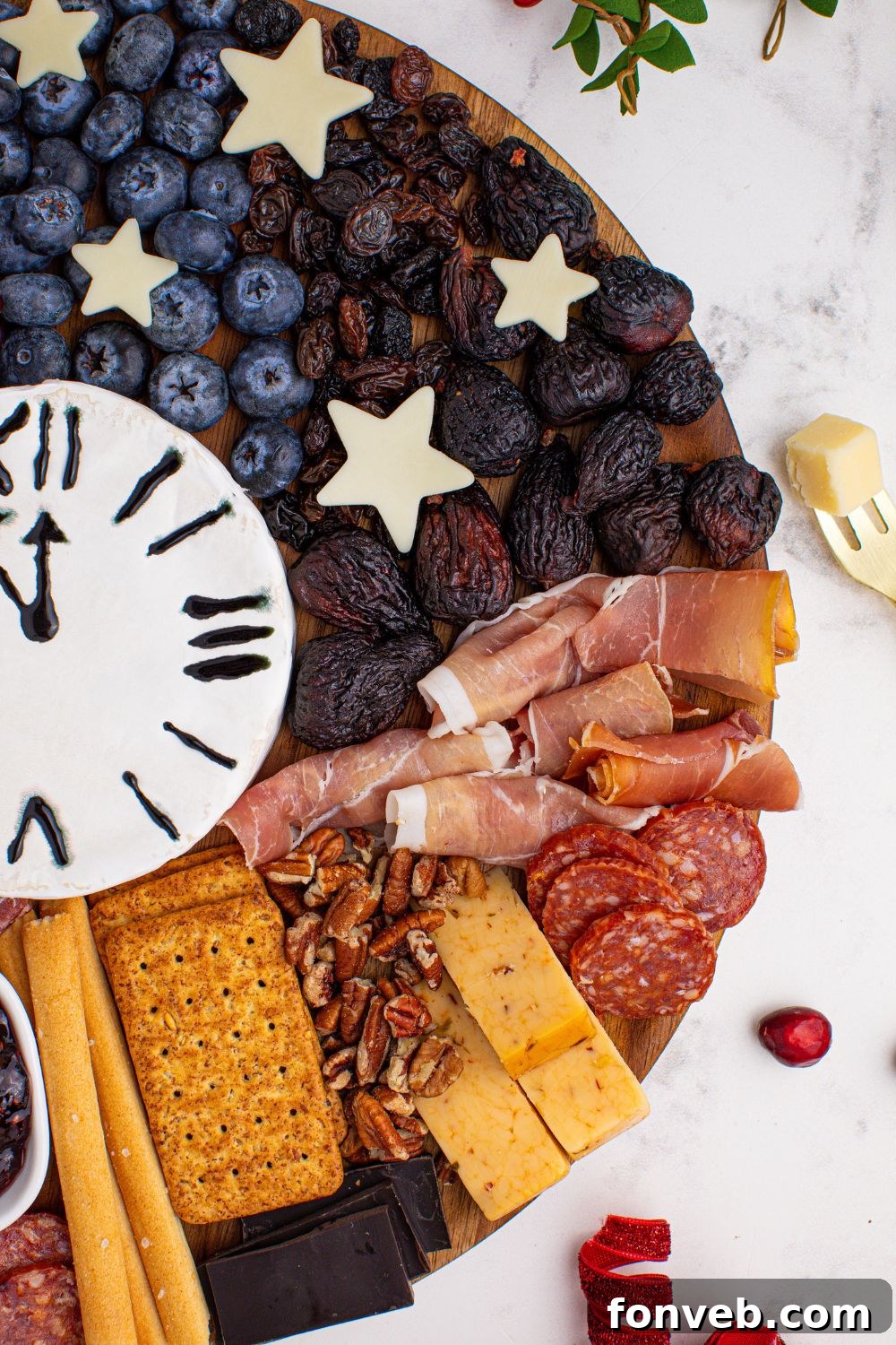 A side view of the New Year's Eve Charcuterie Board, highlighting the artful arrangement of various meats and cheeses, showcasing their appealing textures and colors.