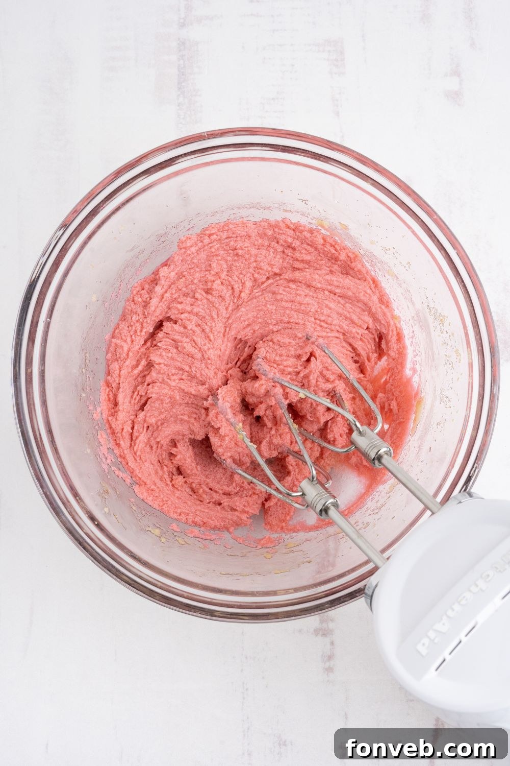 The prochess of mixing up the Cherry Chocolate Chip Cookie dough in a glass bowl 