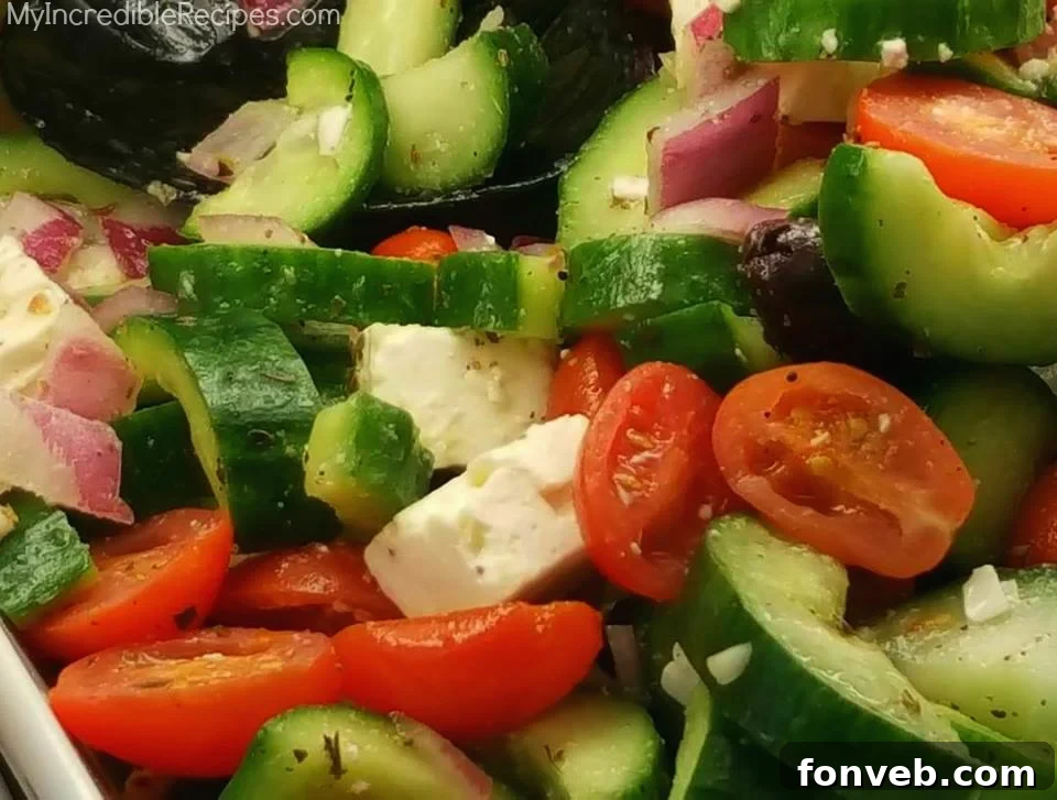 Vibrant Greek Cucumber Salad with fresh tomatoes, cucumbers, feta cheese, and black olives.