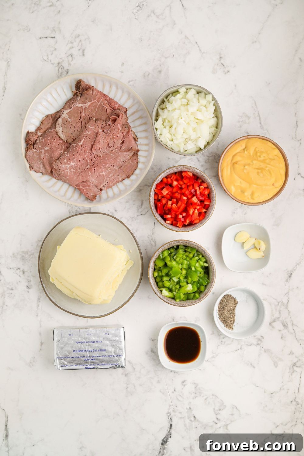 Crock Pot Philly Cheesesteak Dip ingredients on the table in small glass bowls to show all items used
