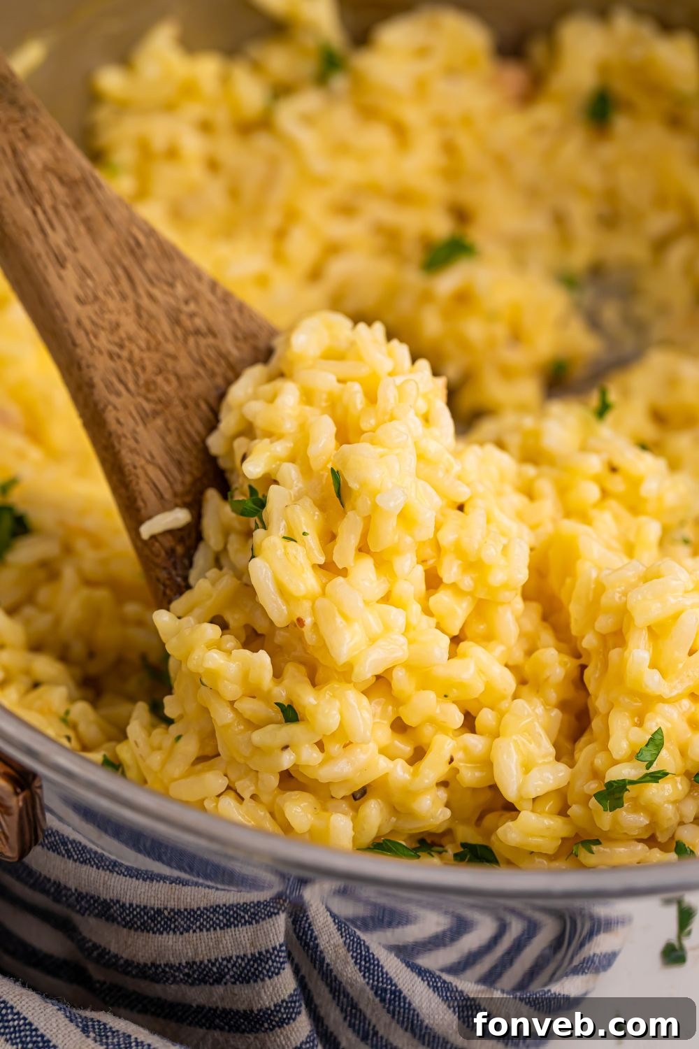 A pan of Souper Rice with a wooden spoon, showcasing its soft texture.