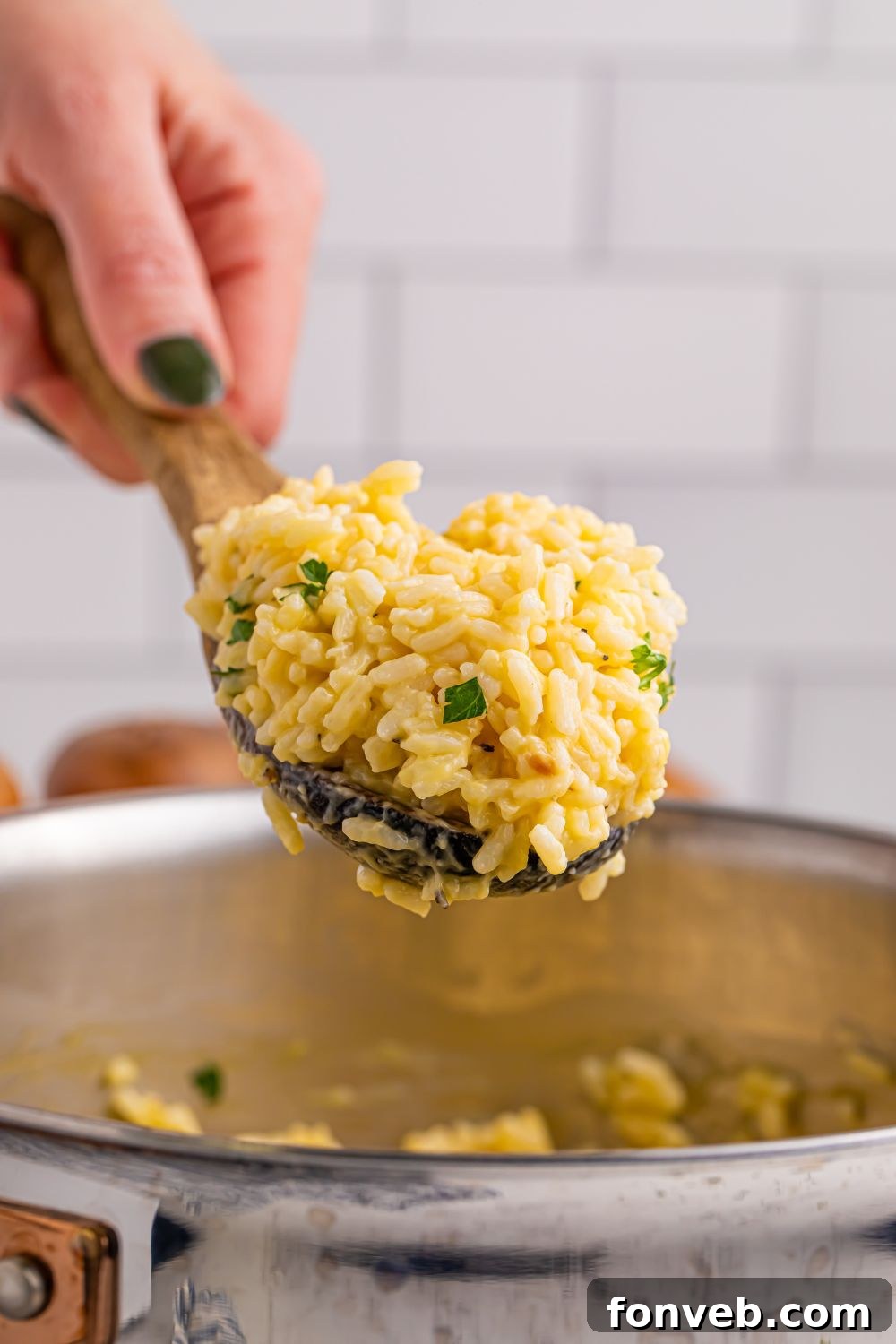 Close-up of Souper Rice being scooped from a pan, highlighting its rich, cheesy consistency.