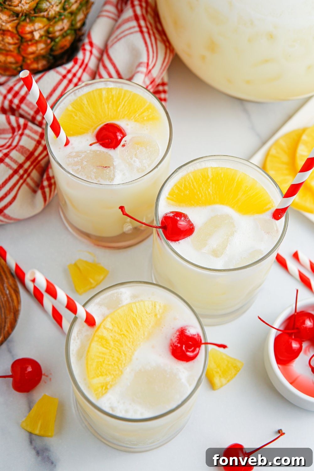 Island Escape Punch 16 Three beautifully garnished glasses of Piña Colada Punch, ready to be served.