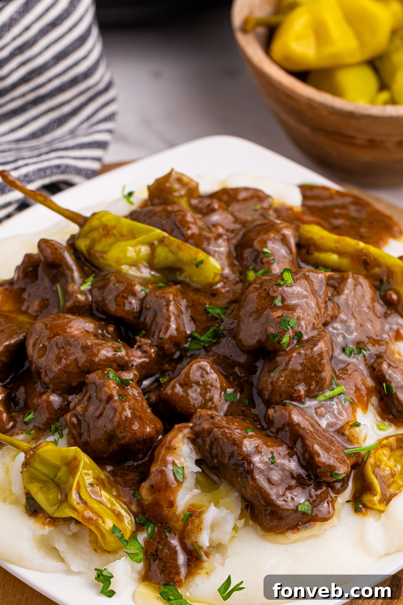 Tender Mississippi Crockpot Steak Bites 13 A generous serving of Mississippi Steak Bites over mashed potatoes, showcasing the rich gravy and tender meat.