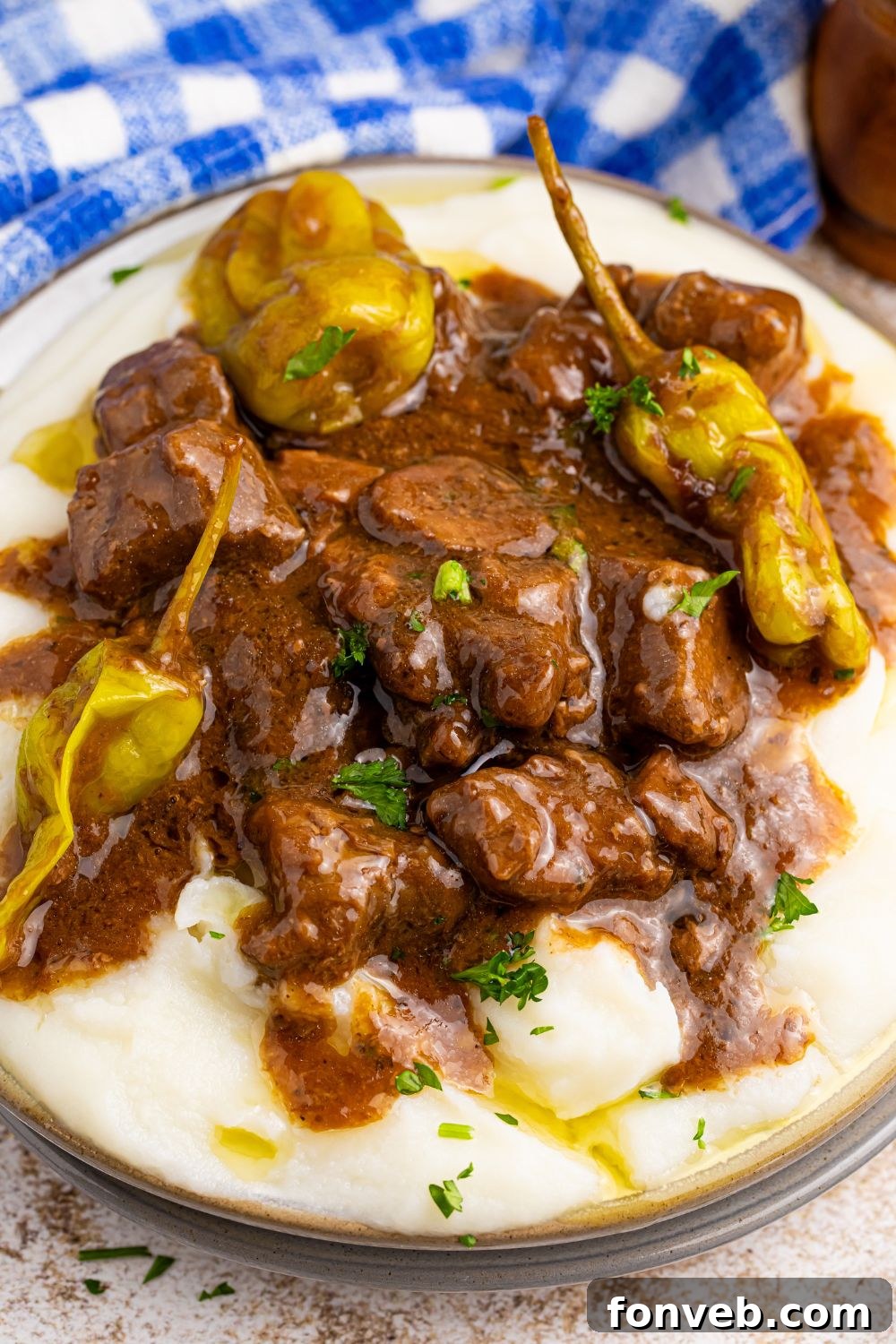 Tender Mississippi Crockpot Steak Bites 17 Close-up view of Mississippi Steak Bites on a plate, showing the tender beef and rich gravy over mashed potatoes.