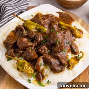 Slow Cooker Mississippi Steak Bites served over mashed potatoes.