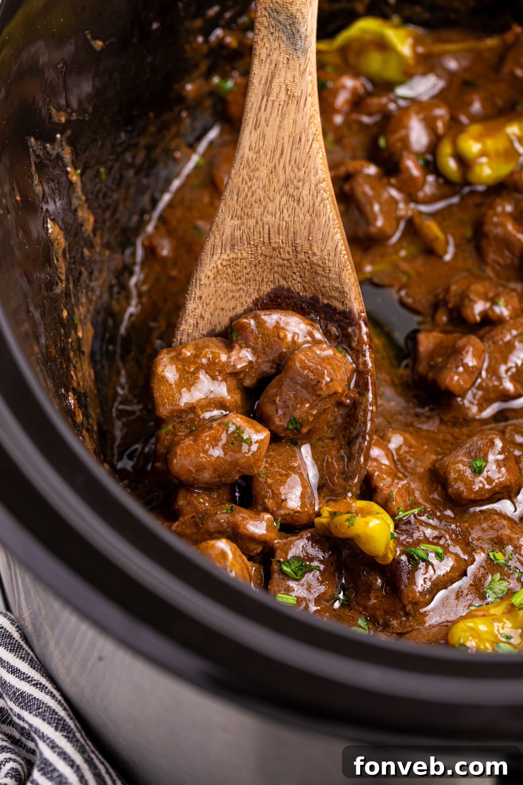 Tender Mississippi Crockpot Steak Bites 4 Close-up view of Mississippi Steak Bites simmering in a slow cooker, showcasing the rich sauce and tender beef.