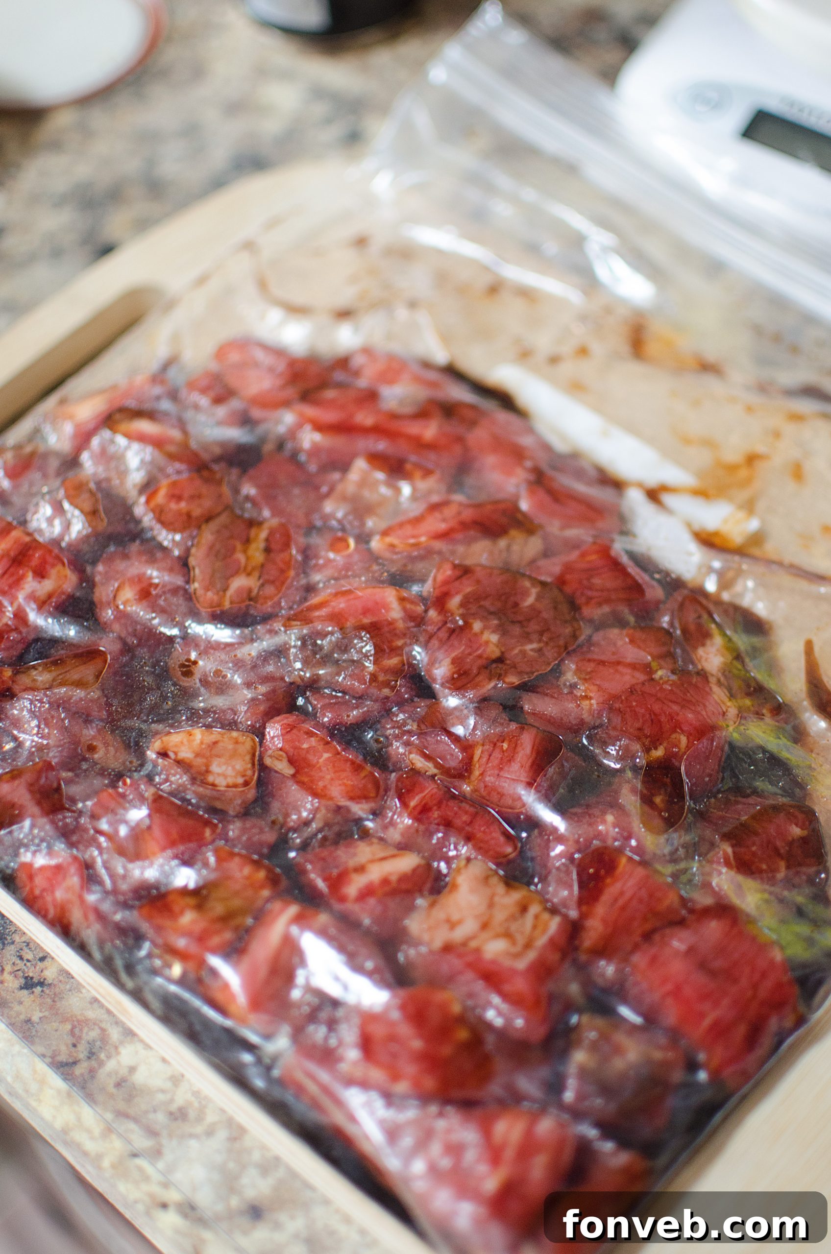 Steak pieces marinating in a flavorful Asian sauce in a bowl