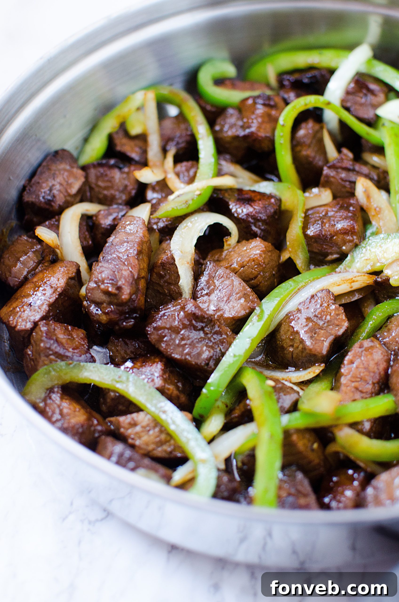 Sliced bell peppers and onions ready for cooking