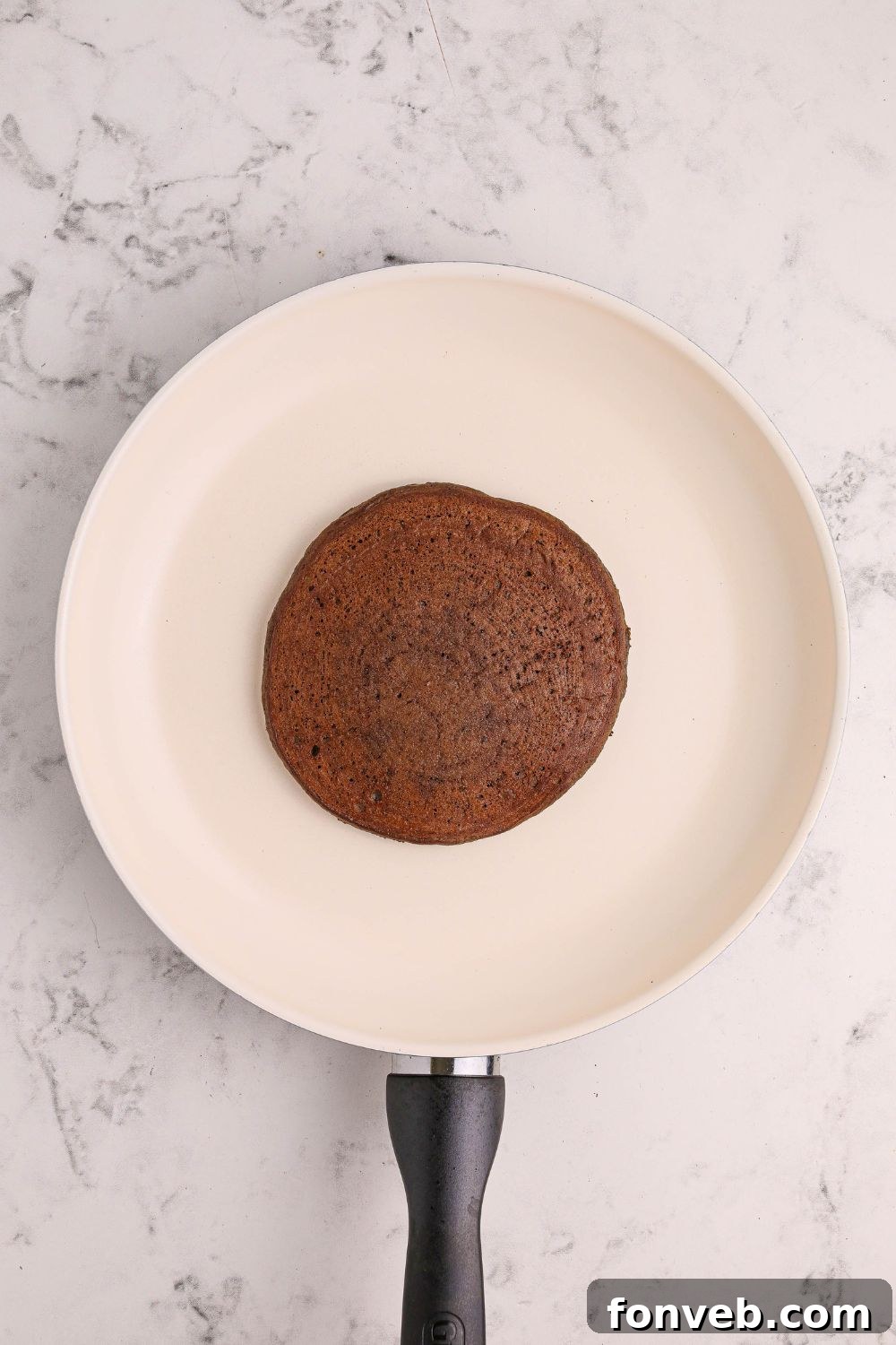 Decadent Hot Chocolate Pancakes 10 cooking a Hot Chocolate Pancake in a skillet on the stovetop