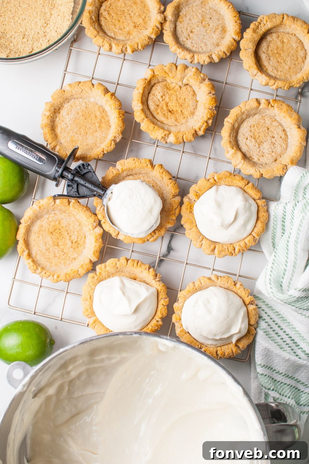 Tangy Key Lime Pie Cookies 13 Crumbl Key Lime Pie Cookie filling being placed in the center of each cookie with the filling