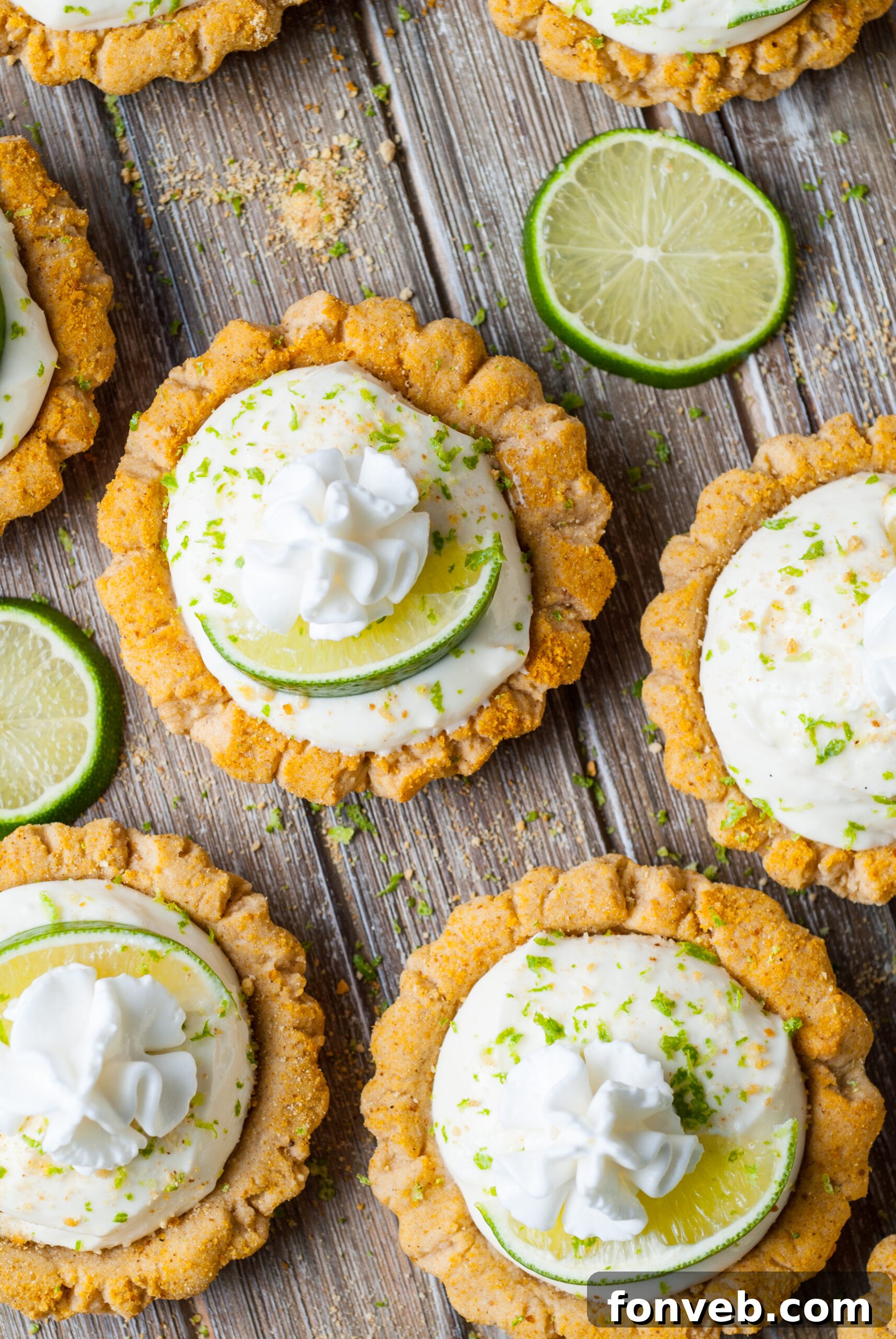 Tangy Key Lime Pie Cookies 22 overhead shot of the Crumbl Key Lime Pie Cookies on table with lime wedges