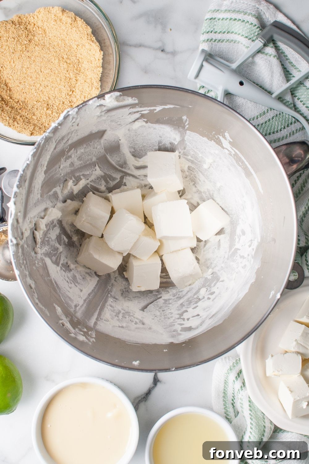 Tangy Key Lime Pie Cookies 9 diced pieces of cream cheese in the bowl for making Crumbl Key Lime Pie Cookies
