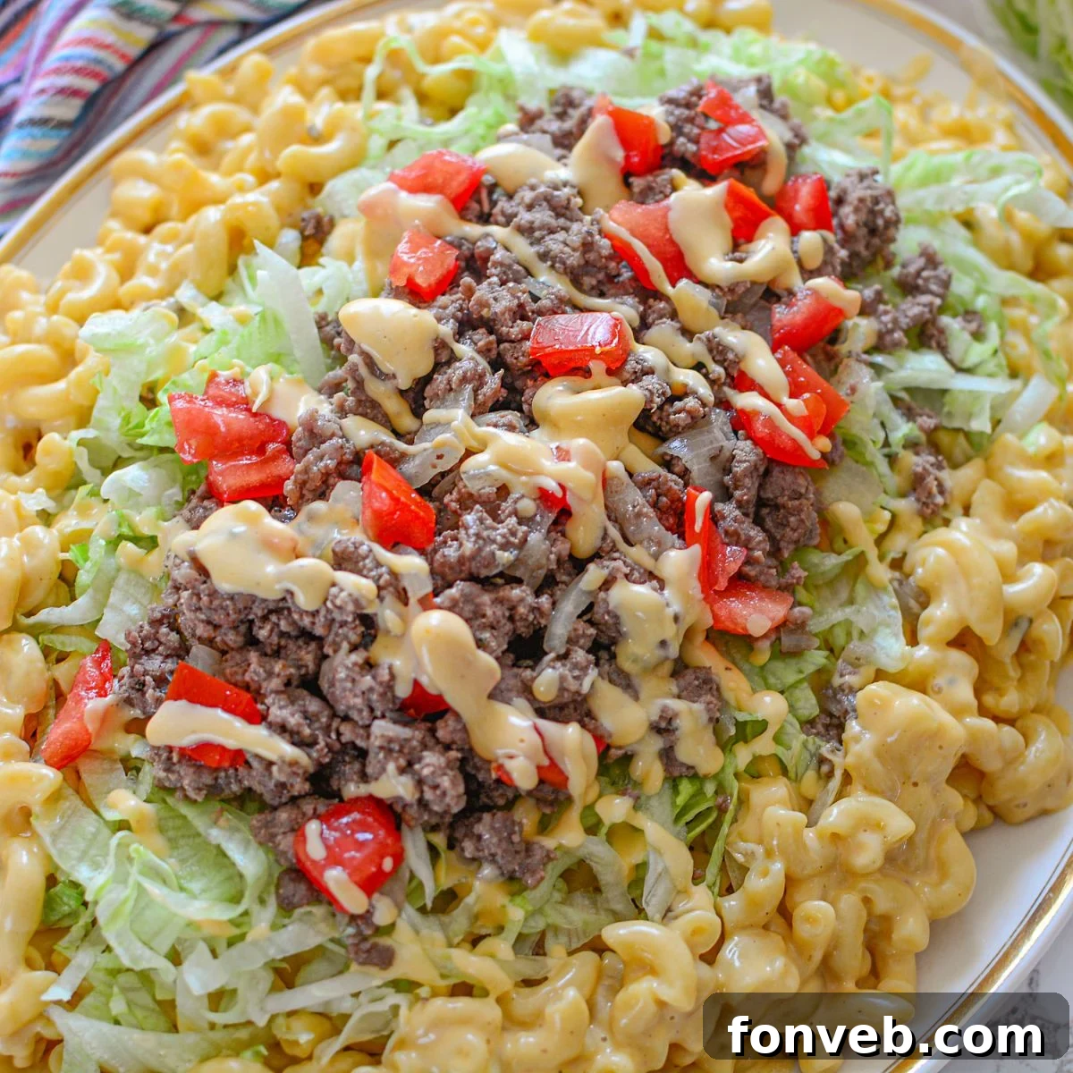 Big Mac Macaroni And Cheese on a platter with macaroni on bottom and Big Mac topper on top of the macaroni 