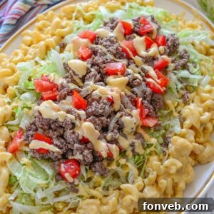 Big Mac Macaroni And Cheese on a platter with macaroni on bottom and Big Mac topper on top of the macaroni