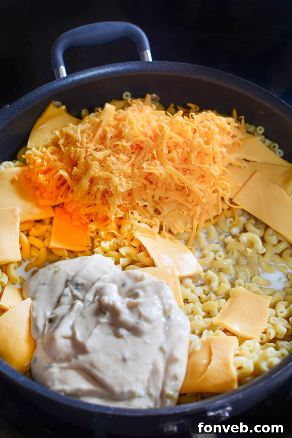 all the cheese in a skillet on the stove for making Big Mac Macaroni And Cheese