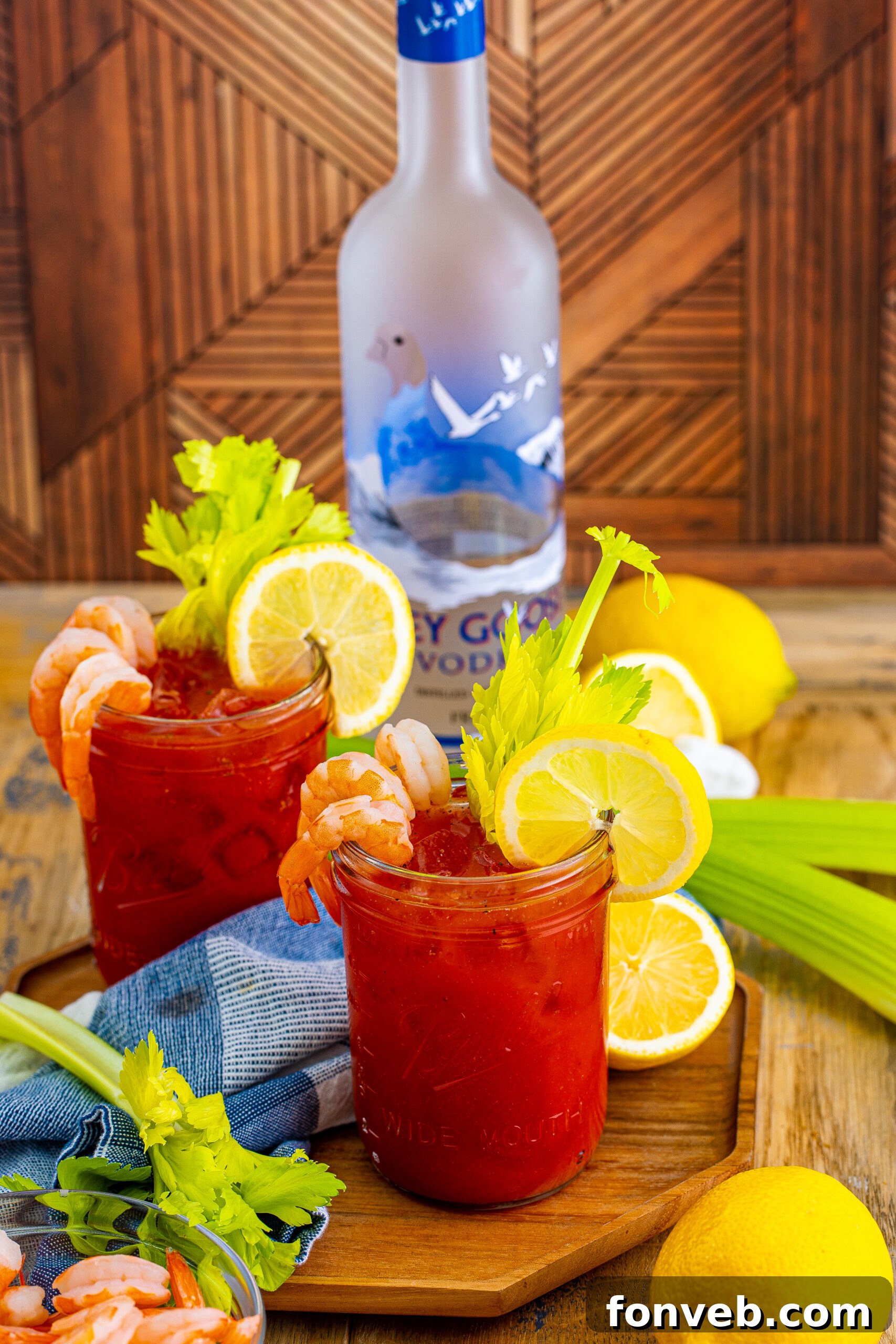 Bloody Mary cocktails on glassess with a bottle of vodka in the background 