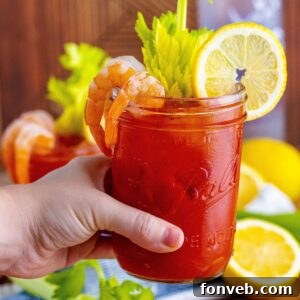 Bloody Mary in hand above table