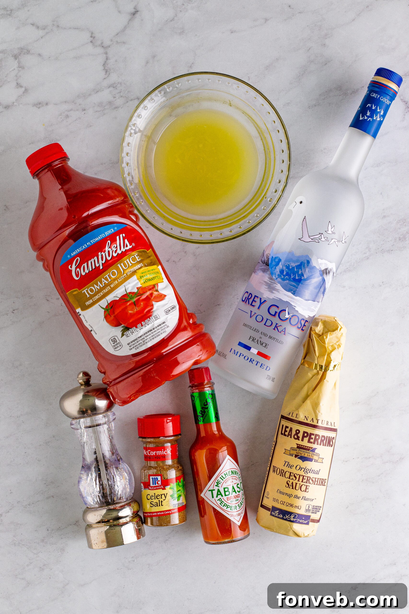 Bloody Mary Drink ingredients on a white marble table 