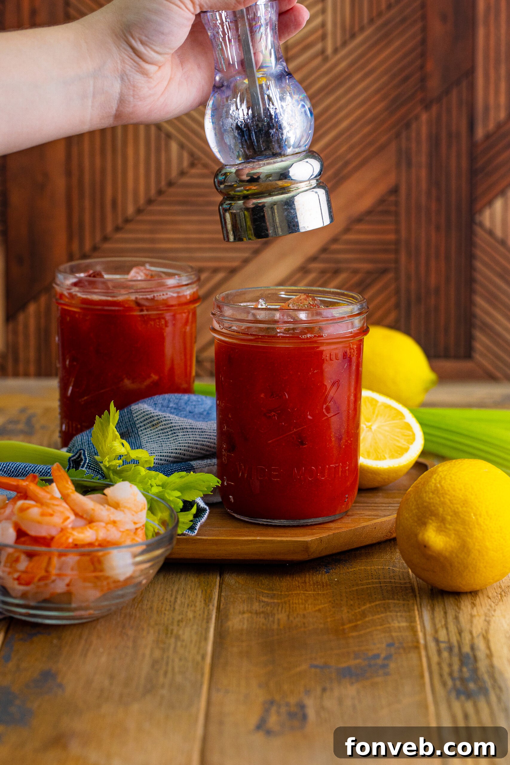 Bloody Mary - adding crushed pepper on top of drink in glass