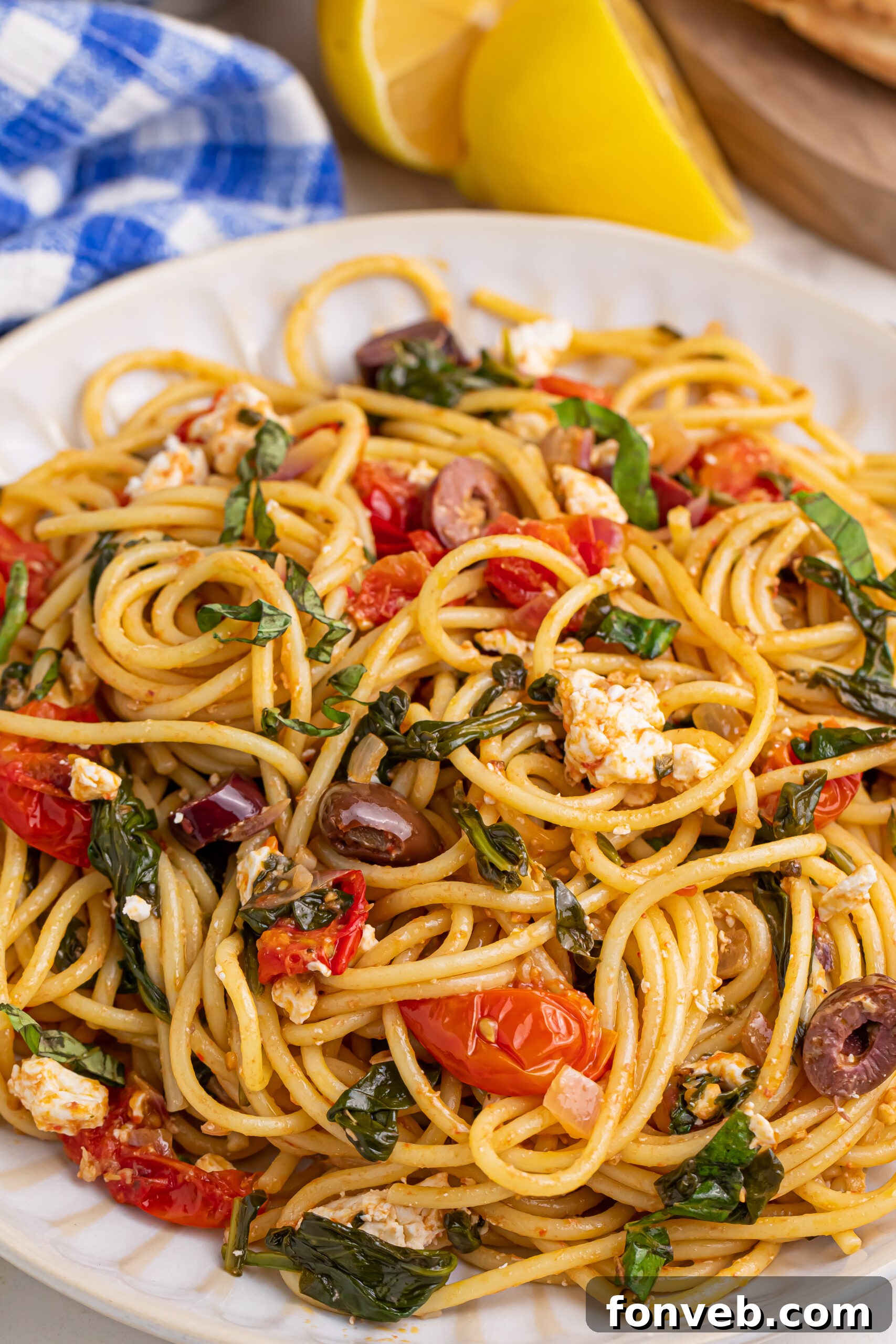 Close up shot of Greek Spaghetti on a white plate, showcasing the rich colors and textures of the dish.