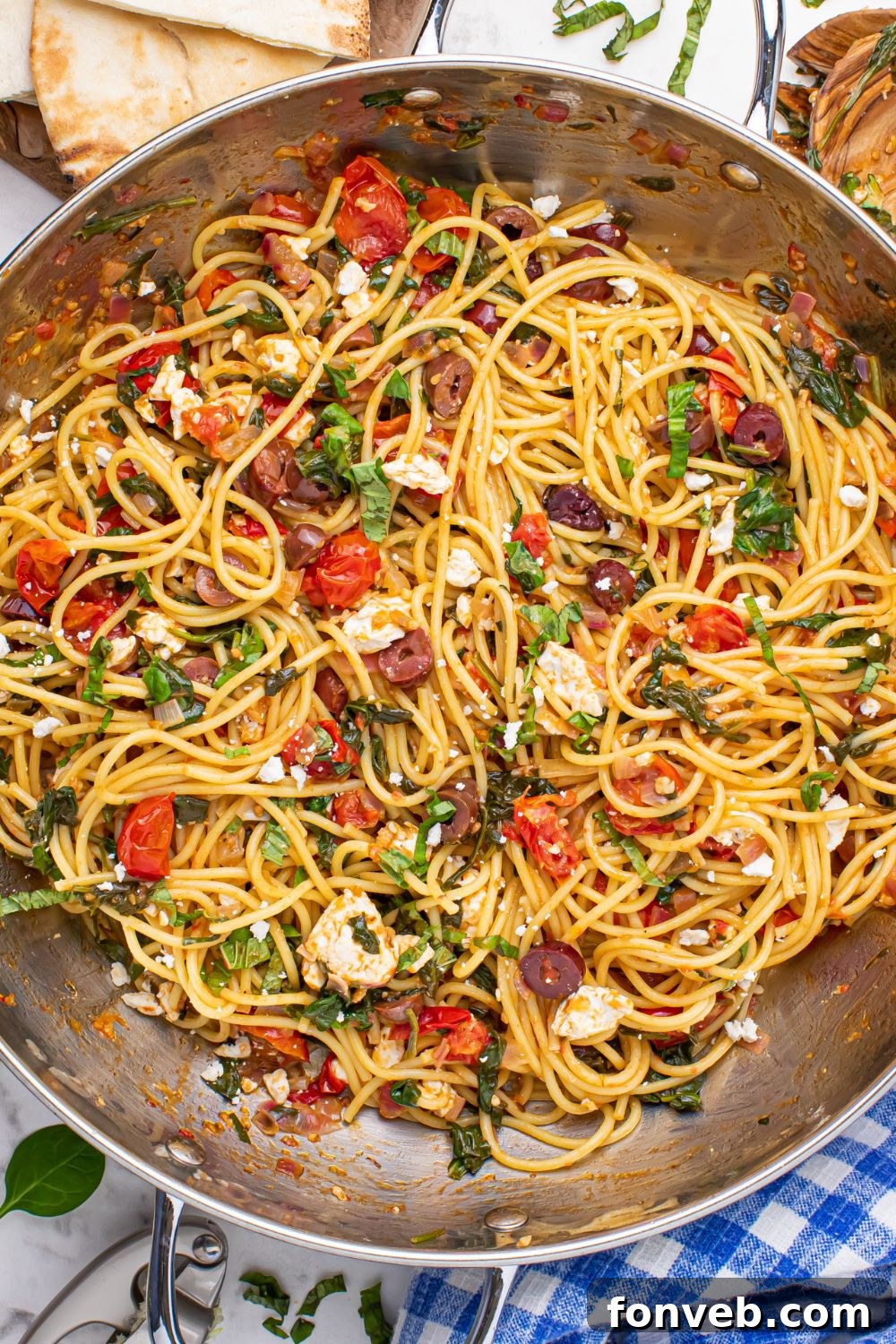 Greek Spaghetti tossed in a pan on table