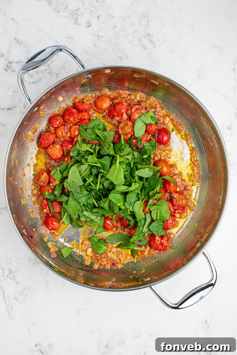 tomatoes and basil in a pan sitting on the table
