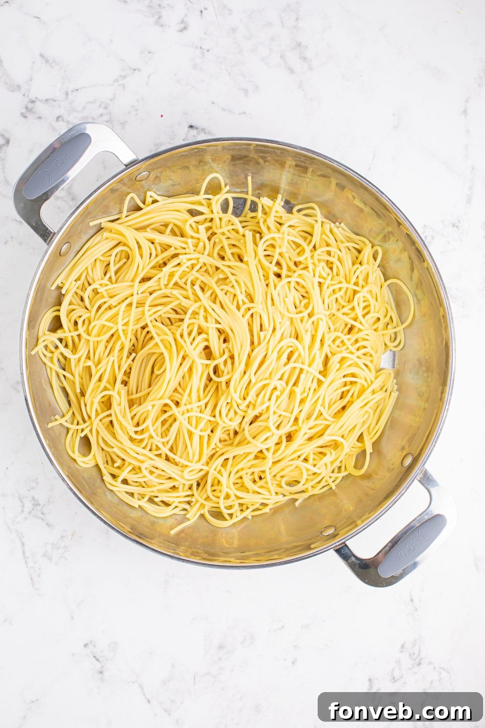 Greek Spaghetti with cooked pasta in a pan on table