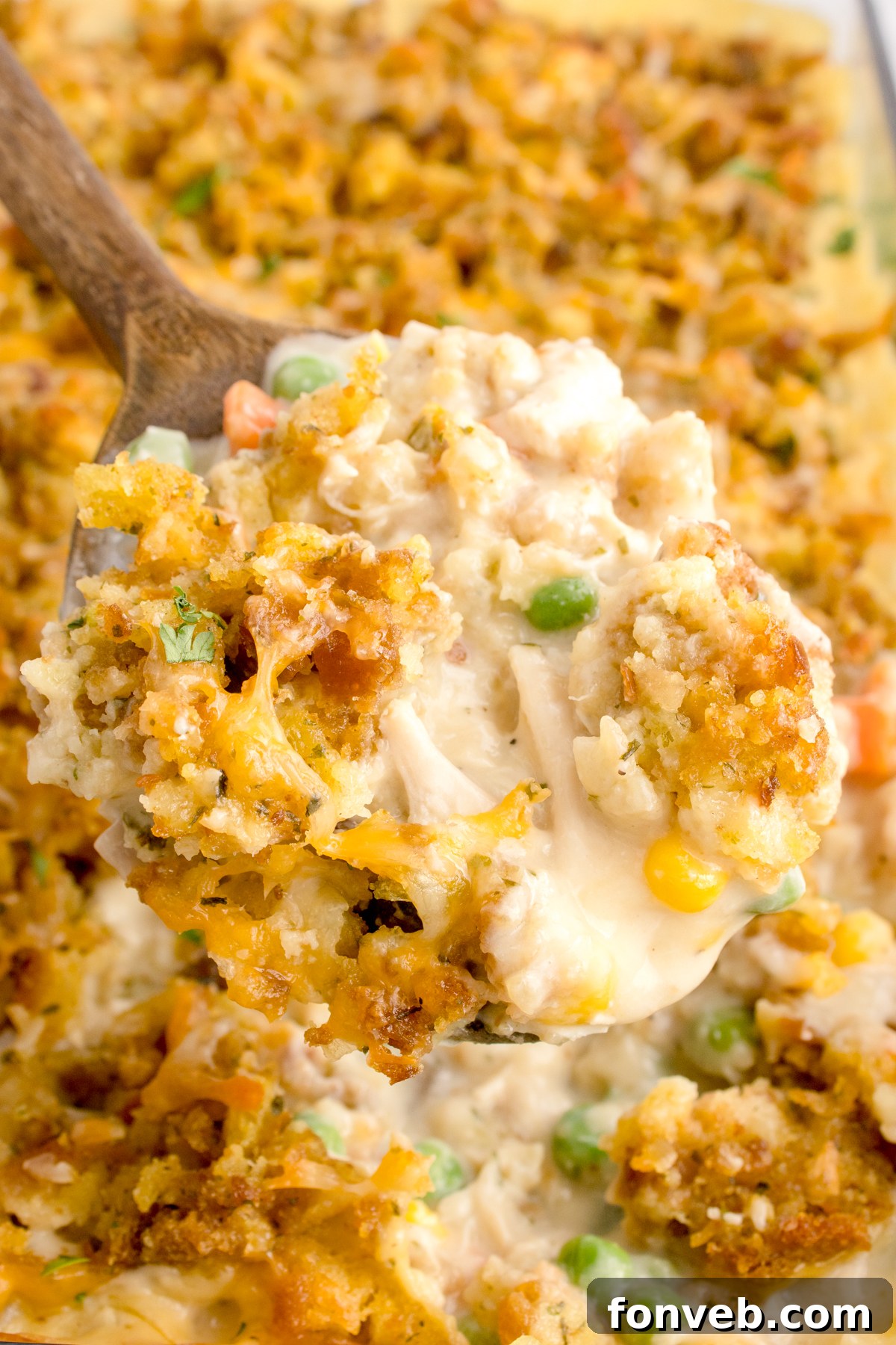 Savory Chicken Stuffing Bake 17 Chicken Stuffing Casserole with a scoop being lifted out of the casserole dish