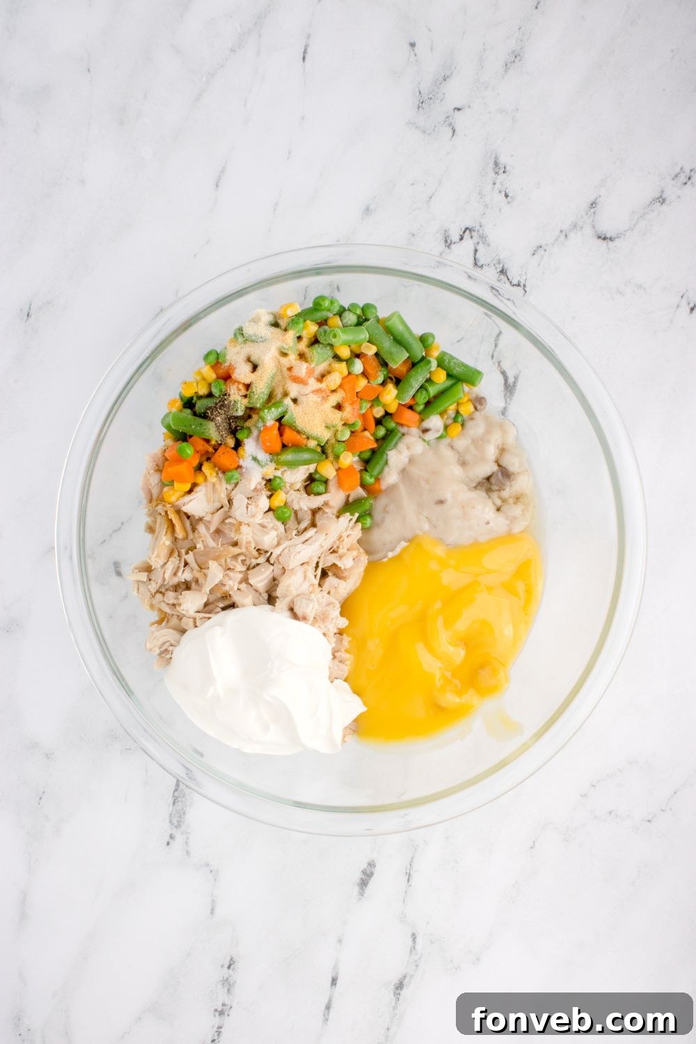 Savory Chicken Stuffing Bake 6 Chicken Stuffing Casserole ingredients in a glass bowl on table