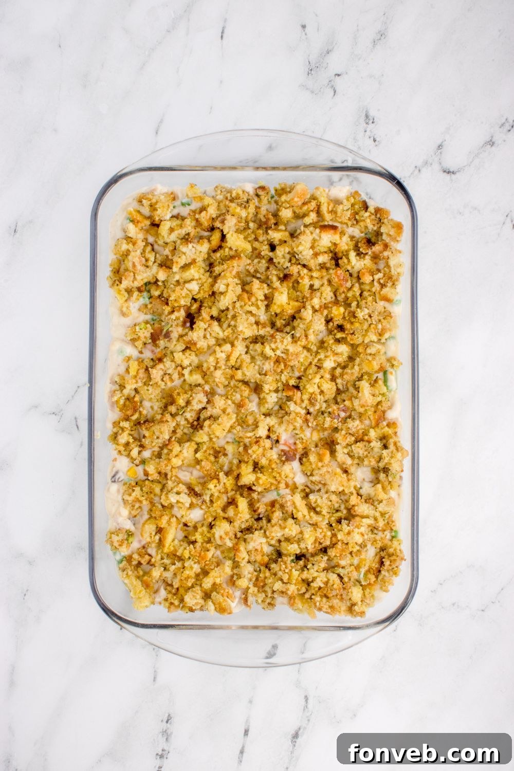 Savory Chicken Stuffing Bake 9 Chicken Stuffing Casserole in a pan unbaked on a marble counter
