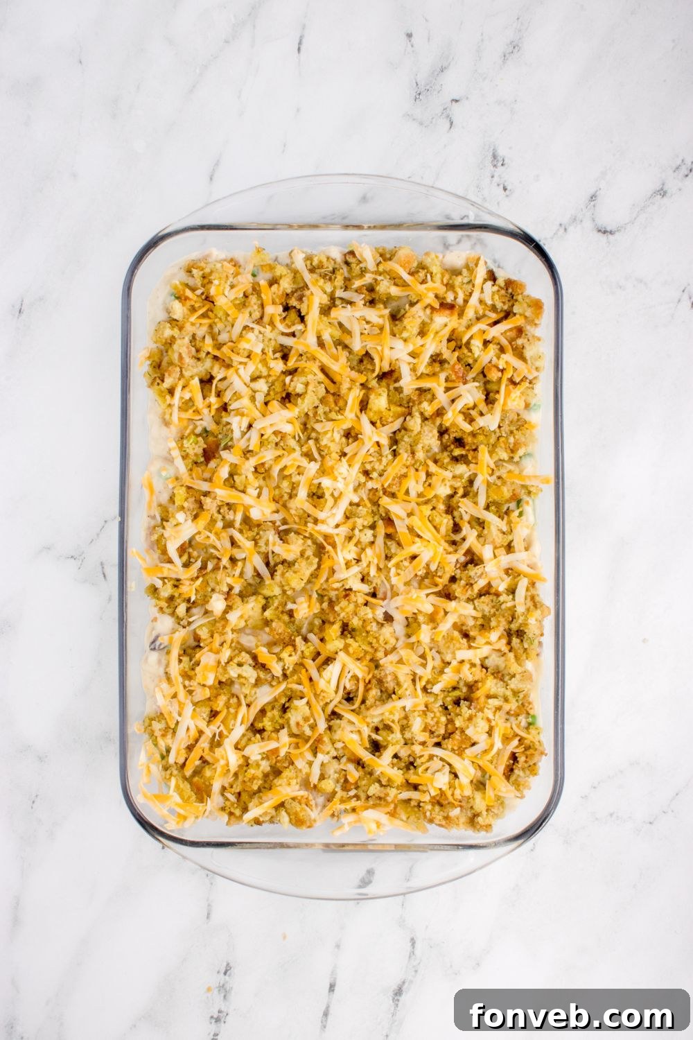 Savory Chicken Stuffing Bake 10 Chicken Stuffing Casserole overhead look with cheese on top of stuffin mix in the casserole pan