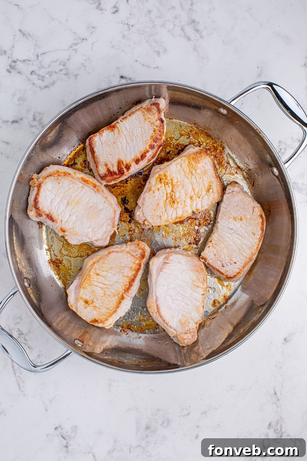 seared pork chops in a pan for making Crock Pot Mississippi Pork Chops