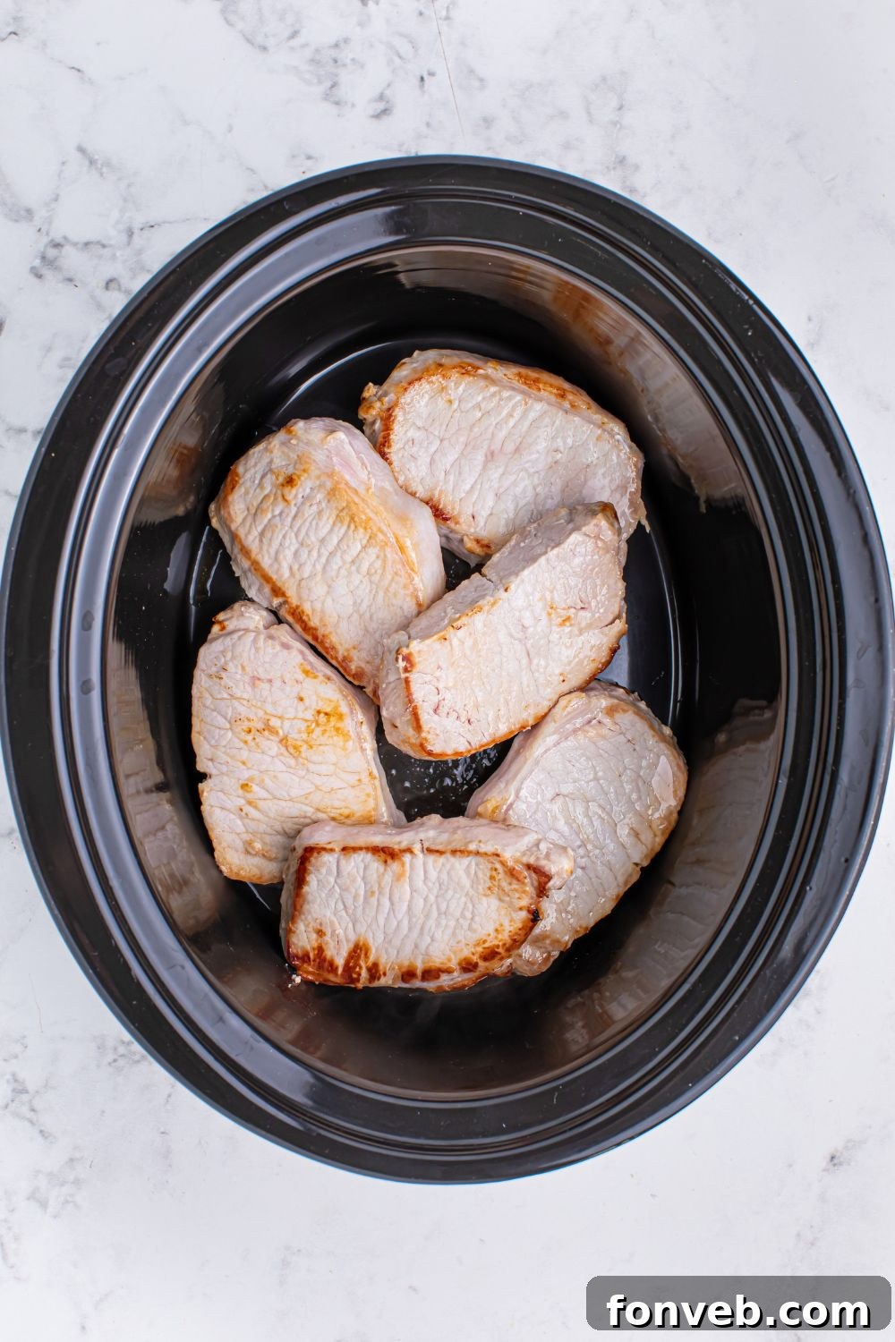 Crock Pot Mississippi Pork Chops in a slow cooker on the table