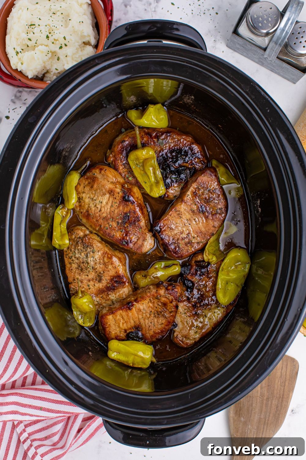 overhead look of Crock Pot Mississippi Pork Chops in a crock pot on table 