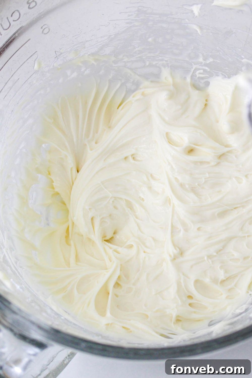 glass  bowl full of the filling for a No Bake Strawberry Delight