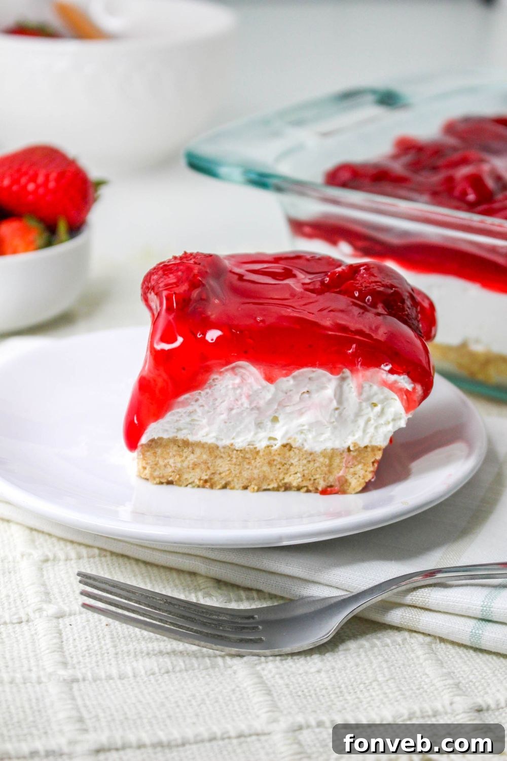 No Bake Strawberry Delight on plate with a fork on table 