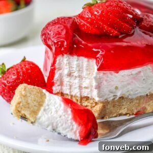 No Bake Strawberry Delight on plate with a fork with a bite taken out of it