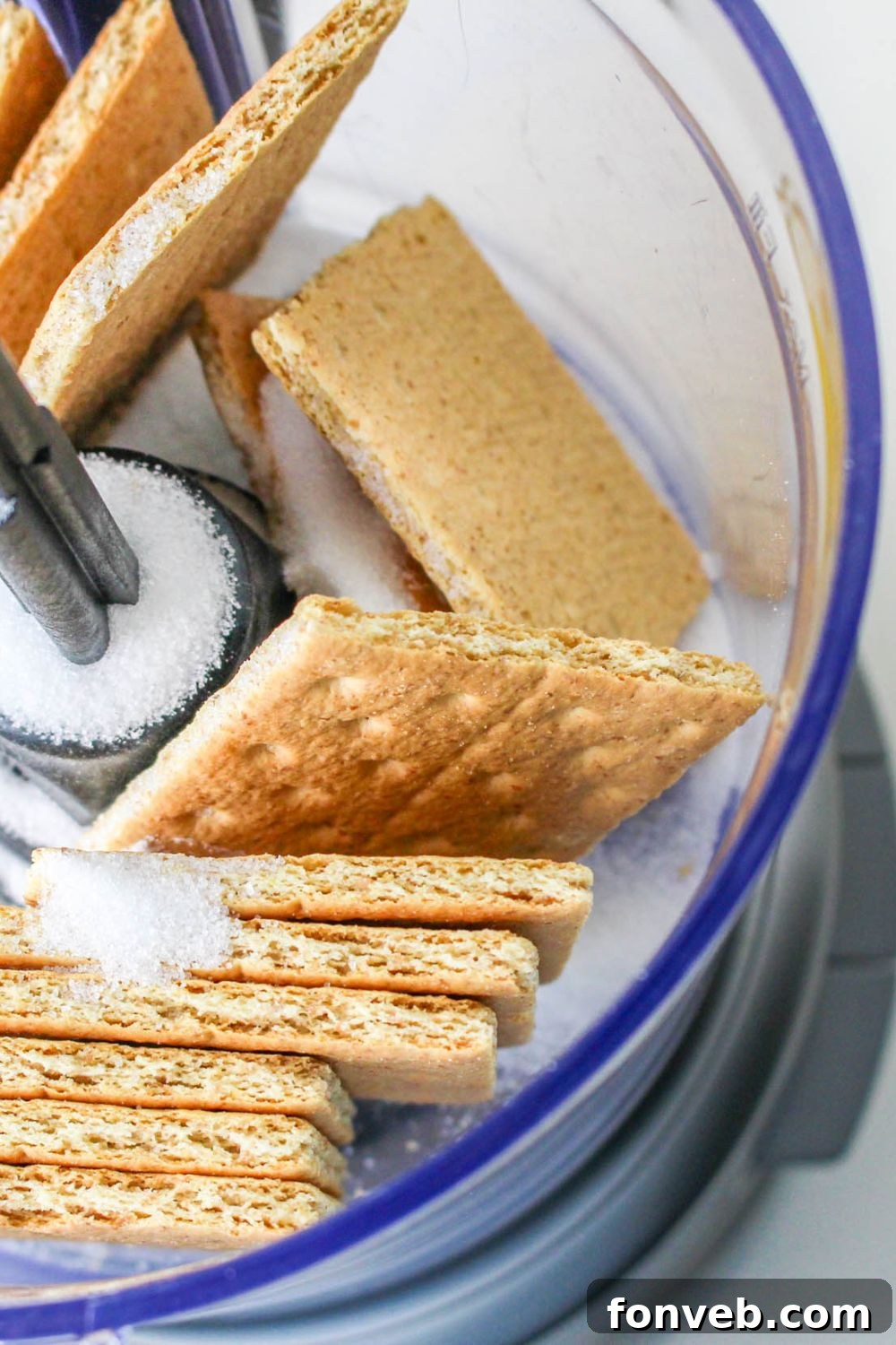 food processor with crackers and sugar in it for making the No Bake Strawberry Delight