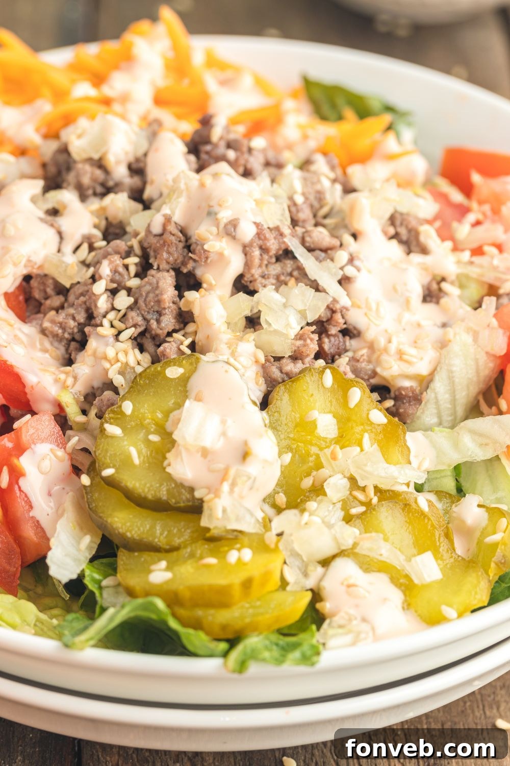 Big Mac Makeover Salad 12 Close-up view of Big Mac Salad in a bowl on a table, showcasing the vibrant toppings and rich detail of the ingredients.
