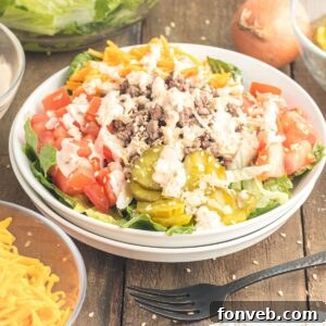 Big Mac Makeover Salad 15 Big Mac Salad in a bowl on table with ingredeints around bowl on table