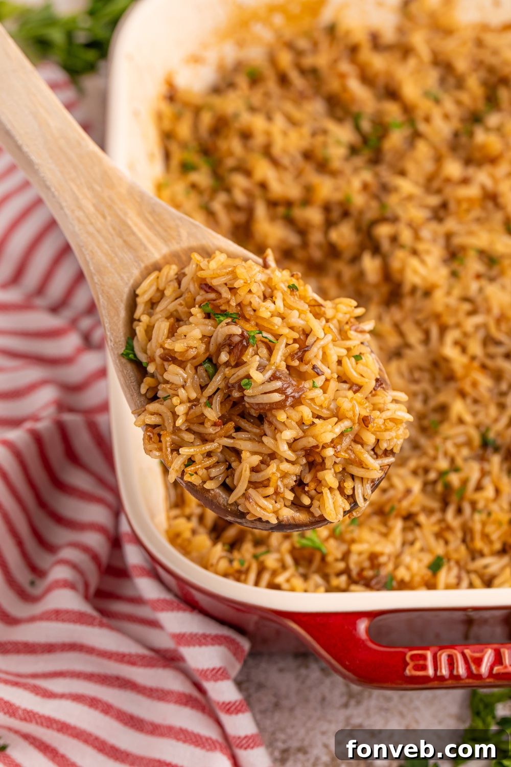 Stick of Butter Rice in a caserole dish with a spoon full of rice