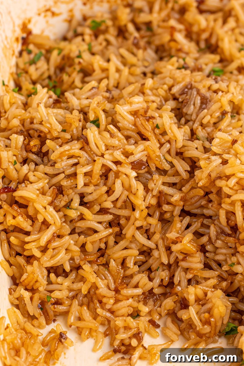 Stick of Butter Rice on a plate with some of the rice gone off plate 