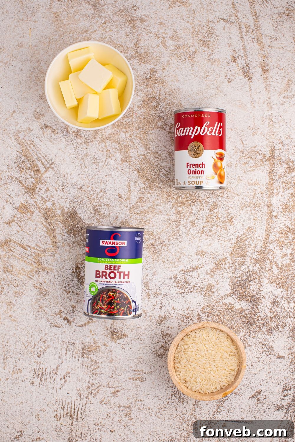 Stick of Butter Rice ingredients on a table in bowls and cans