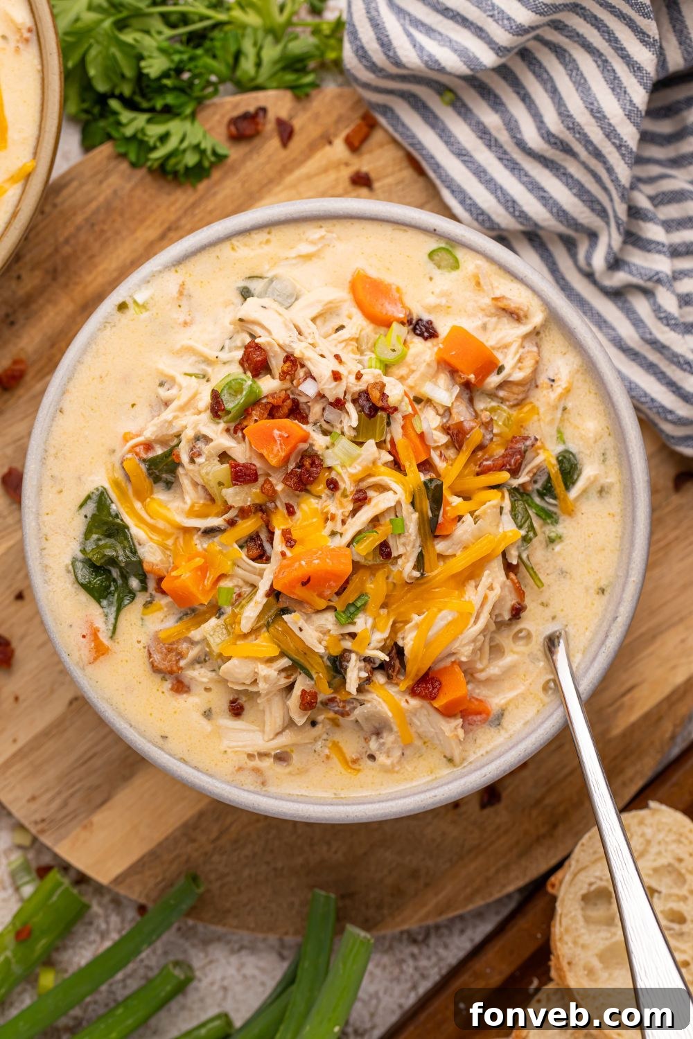 Overhead view of a beautifully presented bowl of Crack Chicken Soup with a spoon, inviting you to dig in