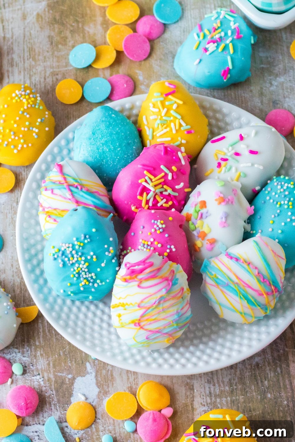 Festive Easter Egg Oreo Truffles 13 An overhead shot of Easter Egg Oreo Truffles elegantly presented on a white plate, showcasing their varied colors and decorations from a top-down perspective, against a simple backdrop.