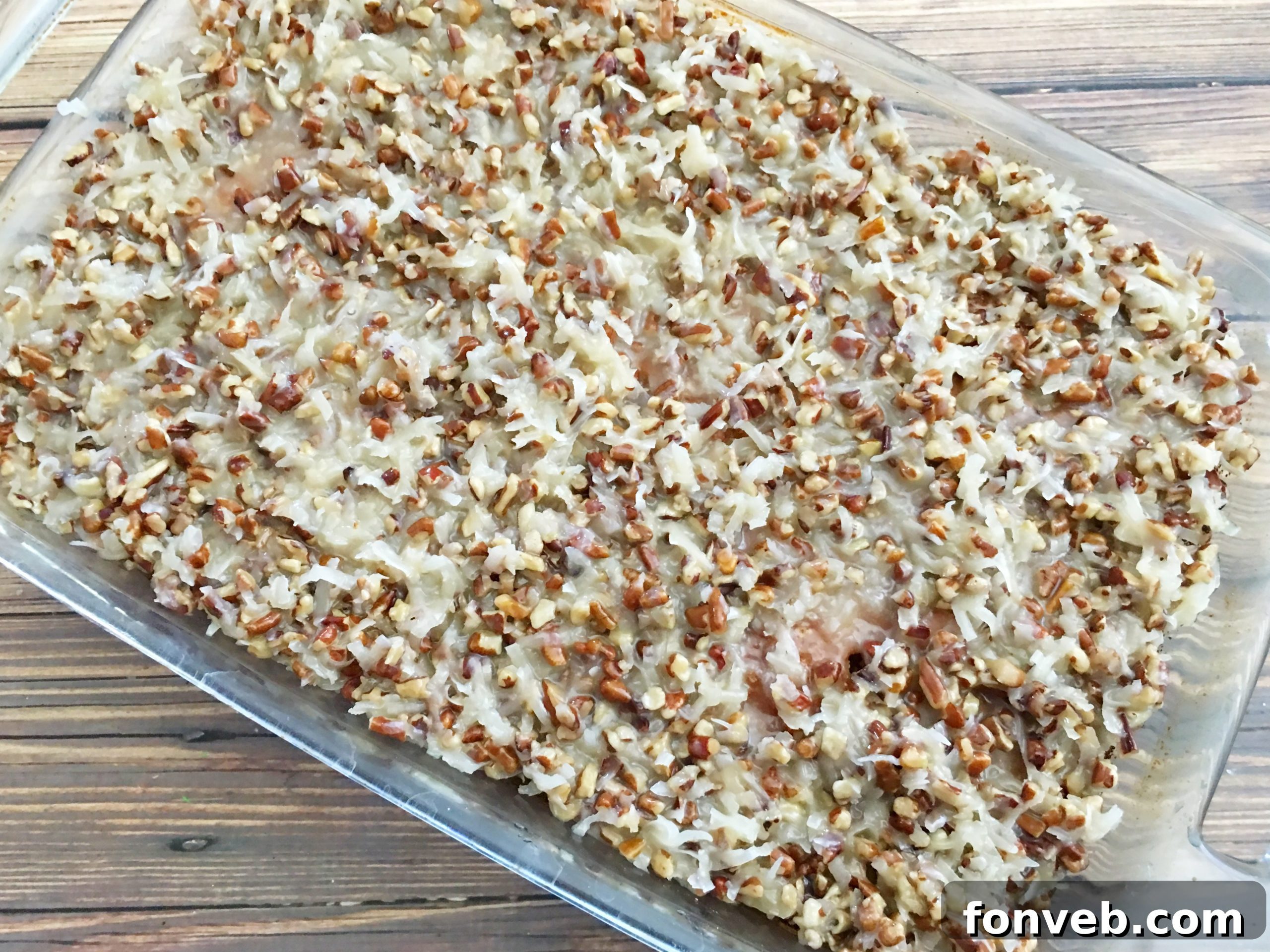 Pouring the warm, sweet topping over the Do Nothing Tornado Cake.