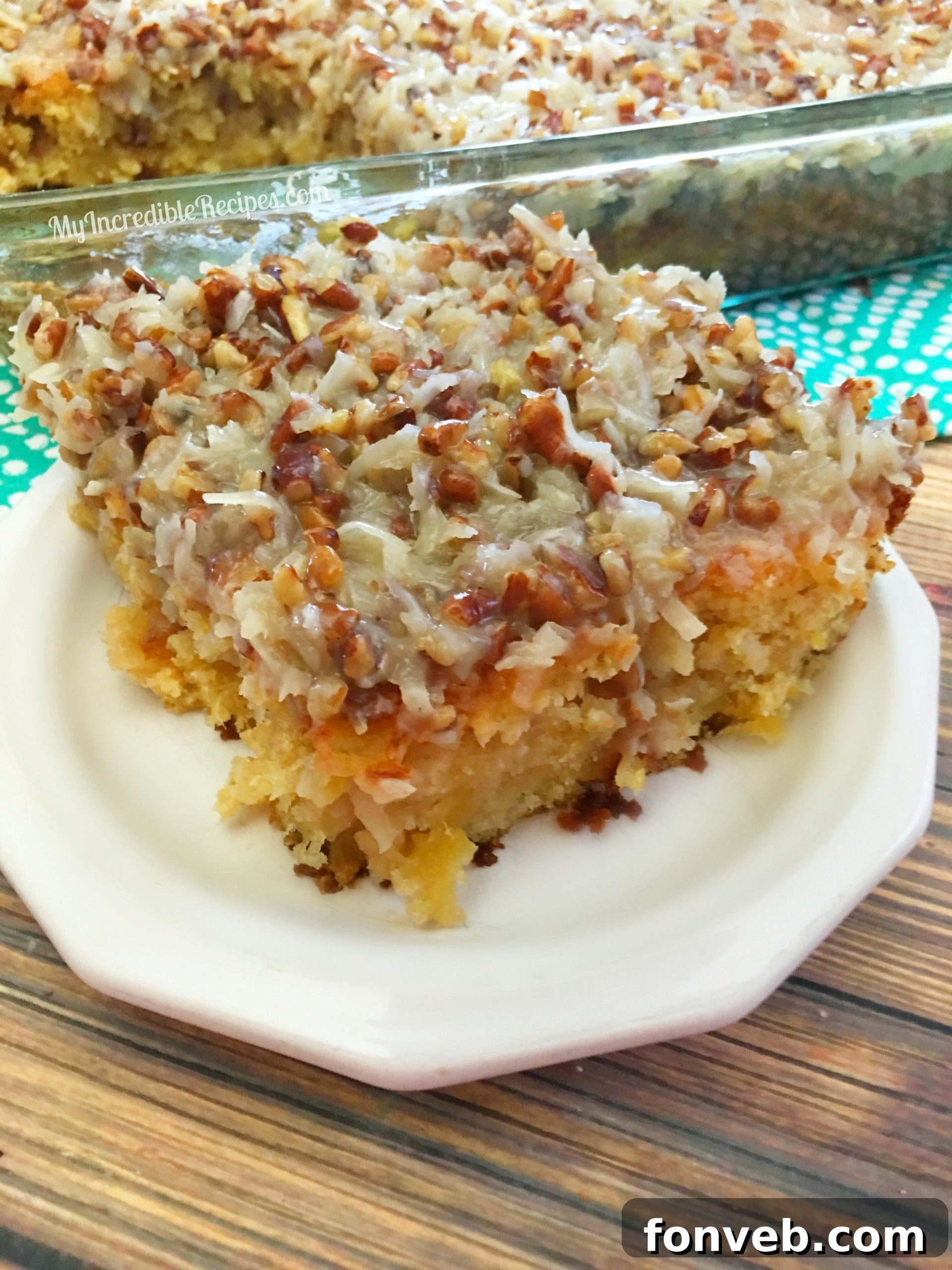 A slice of Do Nothing Tornado Cake on a plate, showing the moist interior and nutty topping.