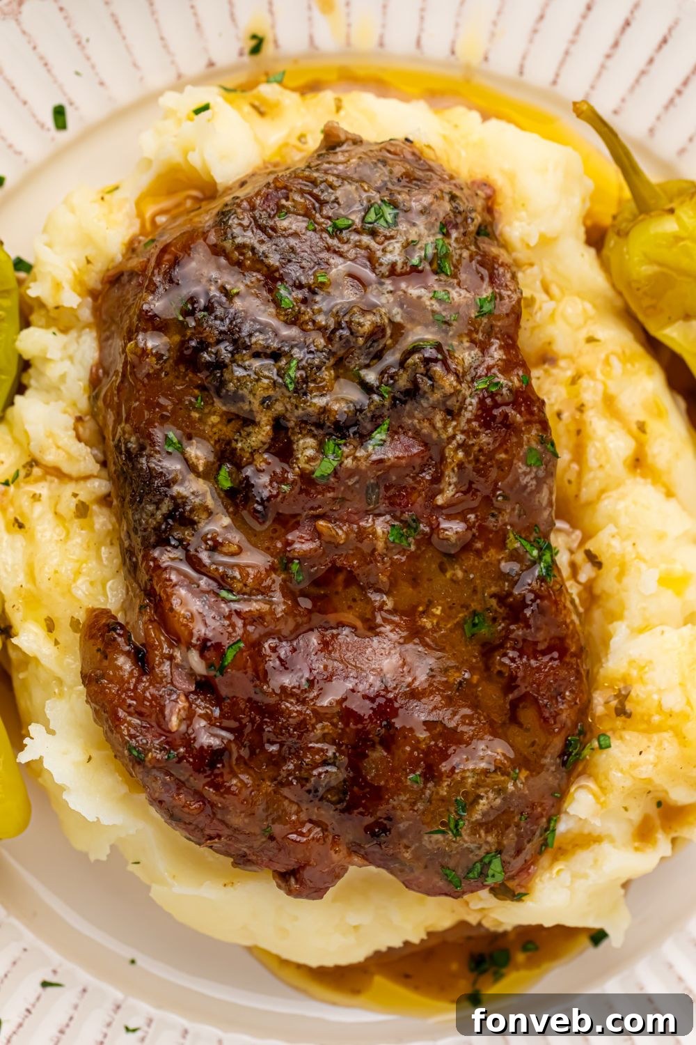 memphis rib eye on plate of mashed potatoes